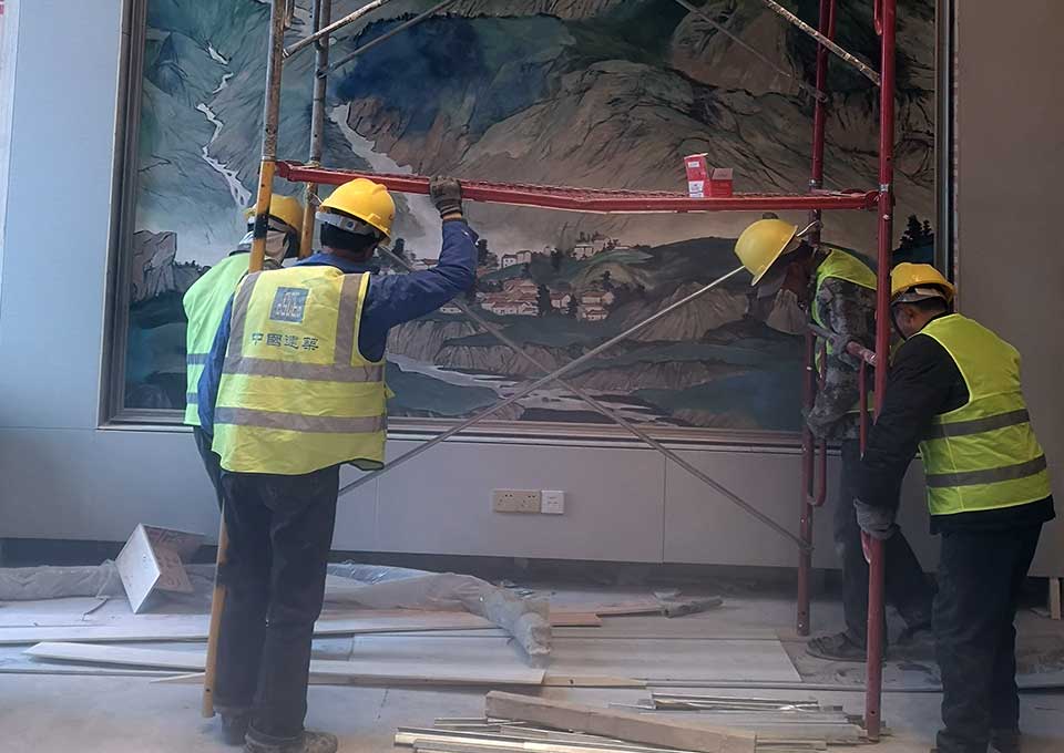 large scale hotel mural installation team working on site