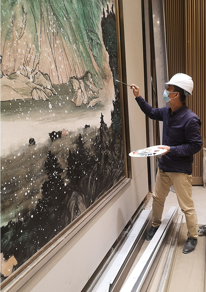 artist creating large scale oil painting in site for hospitality project