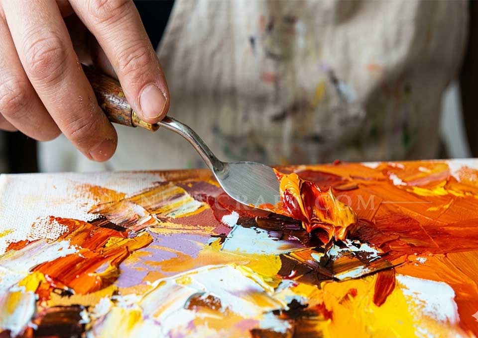 Lumina in Crimson – Gallery-Scale Abstract Impasto Painting 7 Close-up of an artist using a palette knife to apply thick oil paint on canvas.
