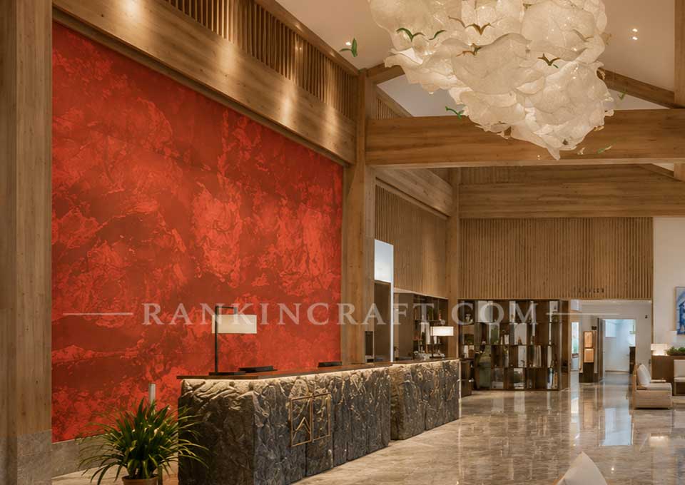 Mountain Resonance: Large-Scale 3D Chinese Landscape Wall Art 7 Side view of a large-scale red wall mural behind the reception desk in a contemporary hotel interior.